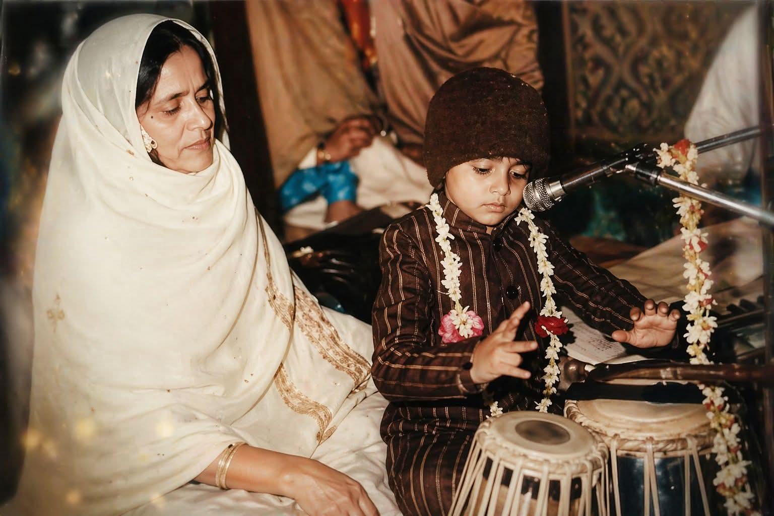 Bhushan Kumar as a child, playing tabla beside his mother